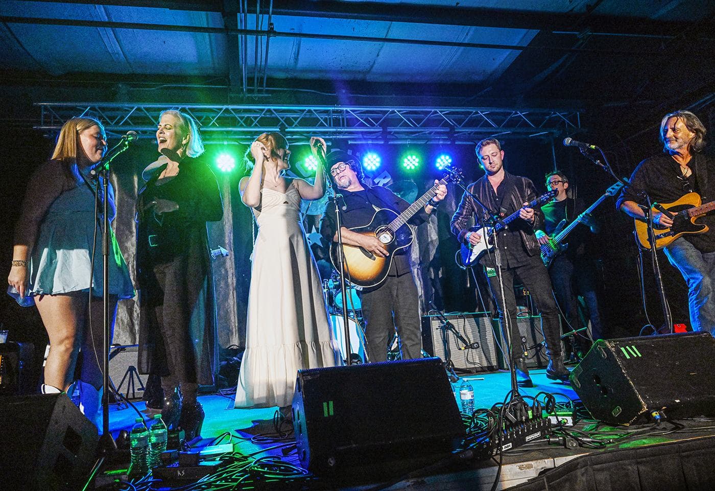 Mia Rogers, Eve Selis, Grace Pettis, Dan Navarro, Cooper Carter, Austin Solomon and Allen Hinds perform during Larry Mitchell's Late Night Jam at John Emerald Distilling Company during the Opelika Songwriters Festival
