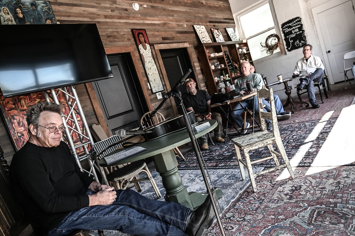 Morning light through the windows of a downtown listening room as a few people settle in