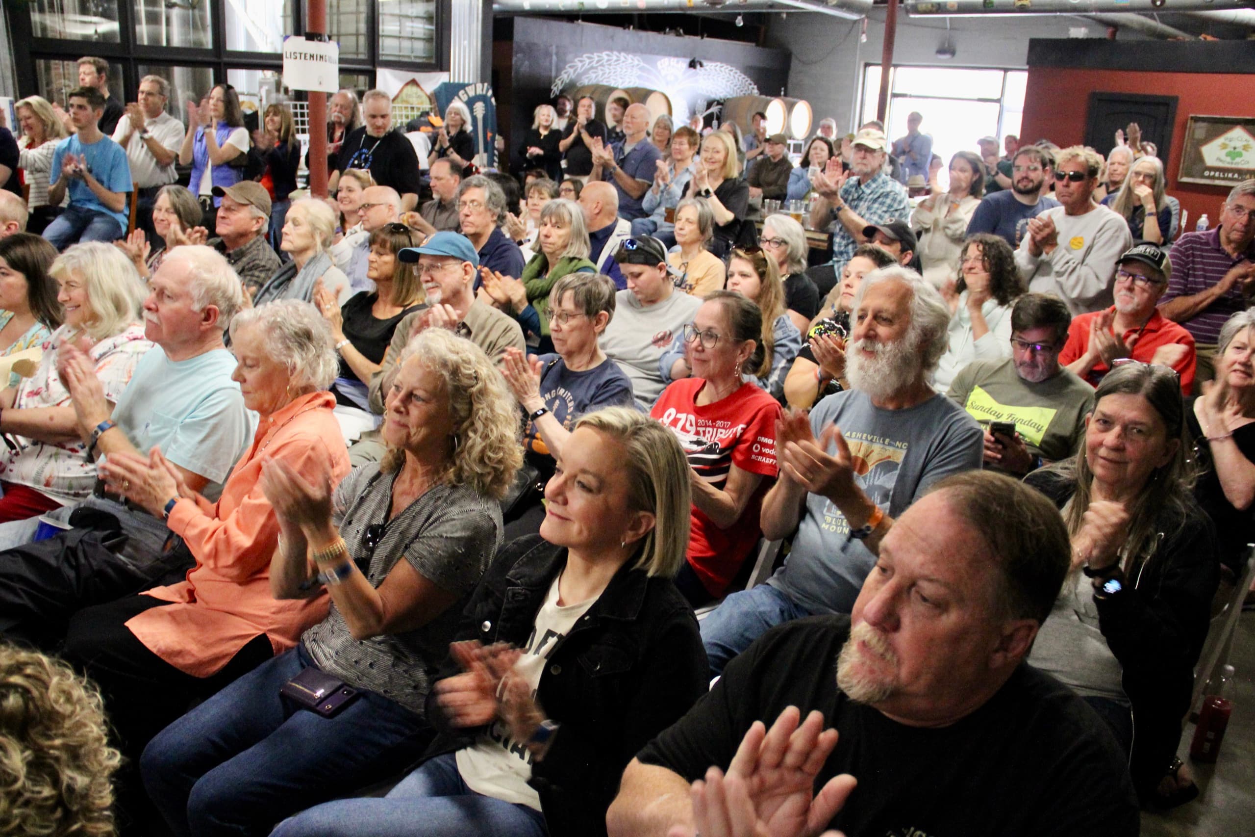A packed listening room applauding a performance during OSF